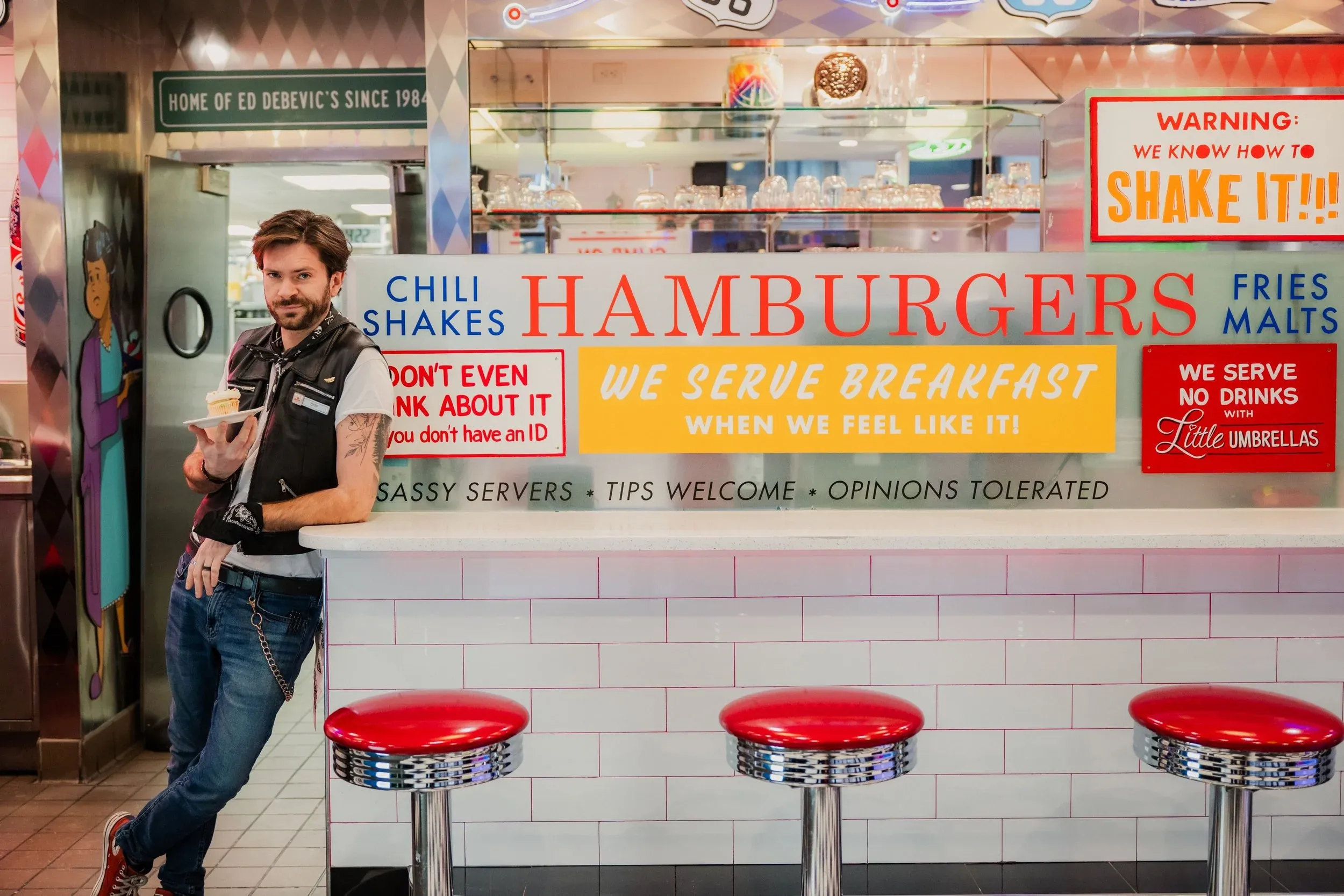 Inside Ed Debevic's retro diner in Chicago — neon signs, checkerboard floors, and servers in 1950s costume